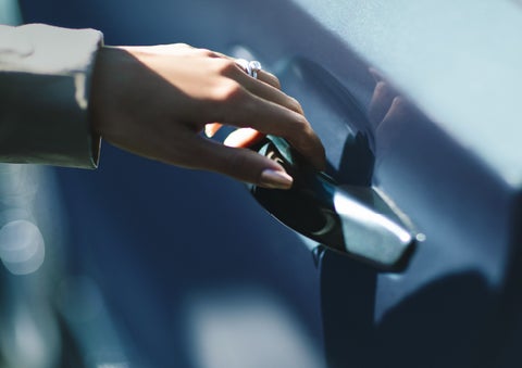 A hand gracefully grips the Light Touch Handle of a 2024 Lincoln Aviator® SUV to demonstrate its ease of use | Wallace Lincoln in Fort Pierce FL