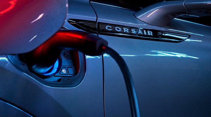 A charger plugged into the charging port of a 2024 Lincoln Corsair® Plug-in Hybrid model. | Wallace Lincoln in Fort Pierce FL