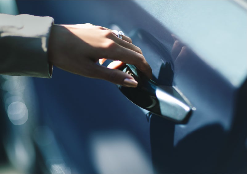 A hand gracefully grips the Light Touch Handle of a 2023 Lincoln Aviator® SUV to demonstrate its ease of use | Wallace Lincoln in Fort Pierce FL