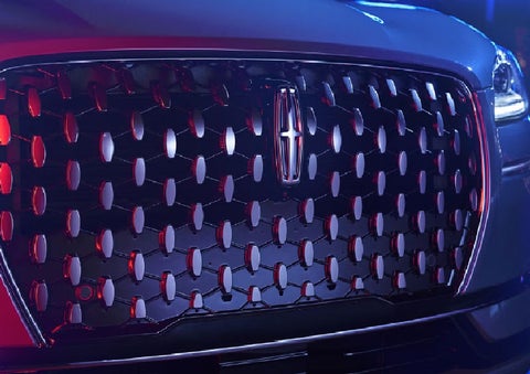 The grille of a 2025 Lincoln Corsair® SUV reflects neon light at night. | Wallace Lincoln in Fort Pierce FL