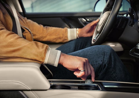 The driver of a 2024 Lincoln Corsair® SUV is shown selecting the drive mode. | Wallace Lincoln in Fort Pierce FL