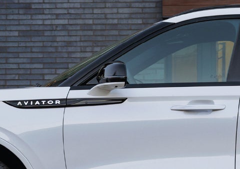 The driver’s side door and fender badging of a white 2026 Lincoln Aviator® SUV are showcased. | Wallace Lincoln in Fort Pierce FL