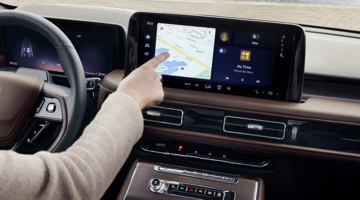 A person is tapping the center display touchscreen of a 2026 Lincoln Aviator® SUV. | Wallace Lincoln in Fort Pierce FL