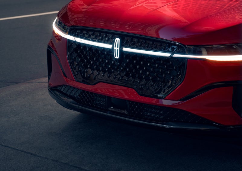 The available front LED light bar and center Lincoln Star logo glow at dusk. | Wallace Lincoln in Fort Pierce FL