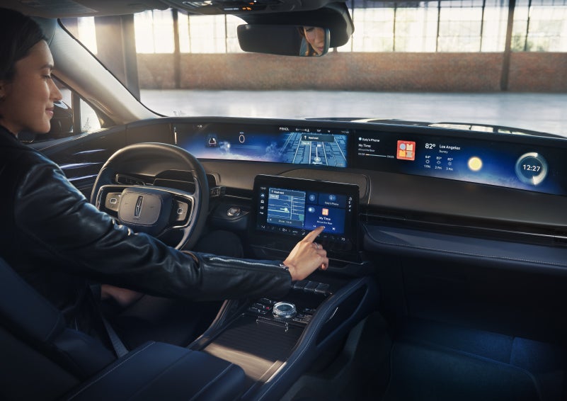 The driver of a 2026 Lincoln Nautilus® SUV interacts with the center touchscreen. | Wallace Lincoln in Fort Pierce FL