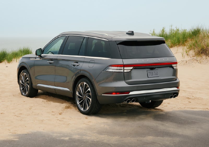A 2027 Lincoln Aviator® SUV is parked next to sand dunes. | Wallace Lincoln in Fort Pierce FL