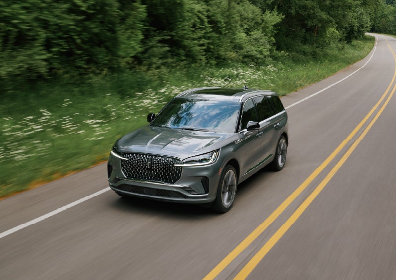 A 2027 Lincoln Aviator® SUV is being driven down a road. | Wallace Lincoln in Fort Pierce FL