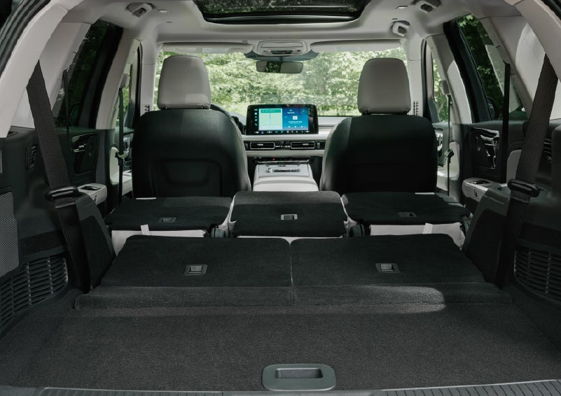 A rear to front view of the interior of a 2027 Lincoln Aviator® Black Label™ SUV shows the third and second rows folded flat | Wallace Lincoln in Fort Pierce FL