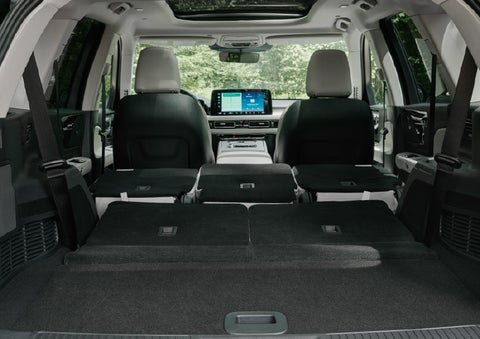 A rear to front view of the interior of a 2027 Lincoln Aviator® Black Label™ SUV shows the third and second rows folded flat | Wallace Lincoln in Fort Pierce FL