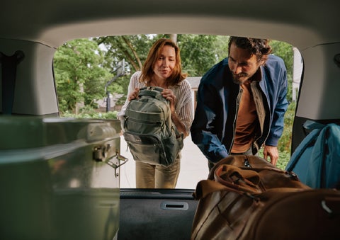 A couple loads luggage into the rear of a 2027 Lincoln Aviator® Black Label™ SUV..e 202 | Wallace Lincoln in Fort Pierce FL