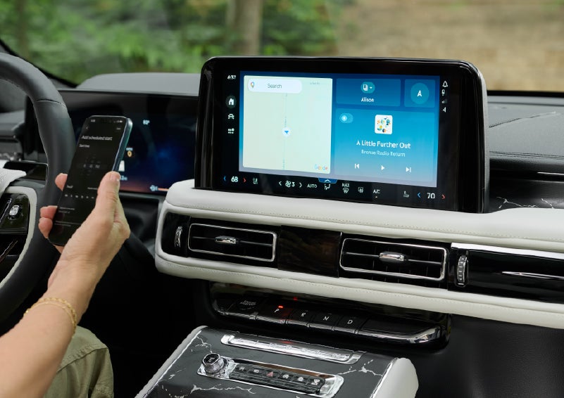 A person pairs thier phone with the center touchscreen of a 2027 Lincoln Aviator® Black Label™ SUV | Wallace Lincoln in Fort Pierce FL